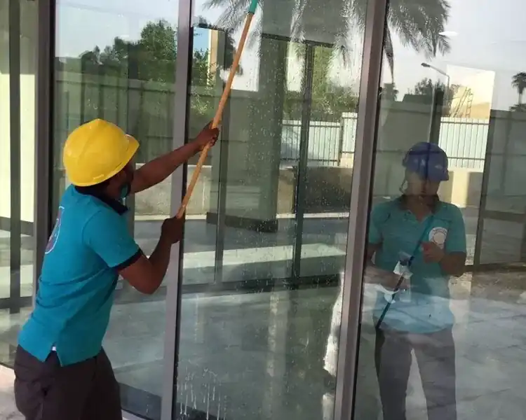 “عمال دار الزين كلين يستخدمون أجهزة حديثة لتنظيف واجهات فيلا في العين.”